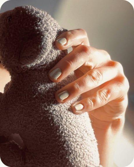 Hands holding a soft toy